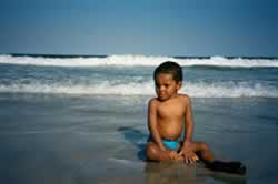 Justin sitting on the beach