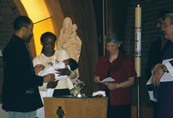 Part of the Baptism ceremony during Mass at the UVM campus church.